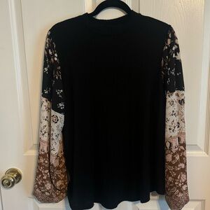 Black knit top with floral sleeves